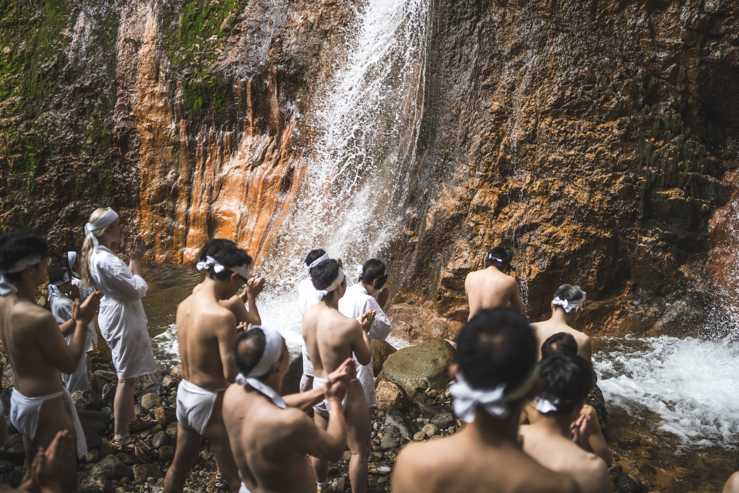 Yamabushi priests praying in front of the waterfall